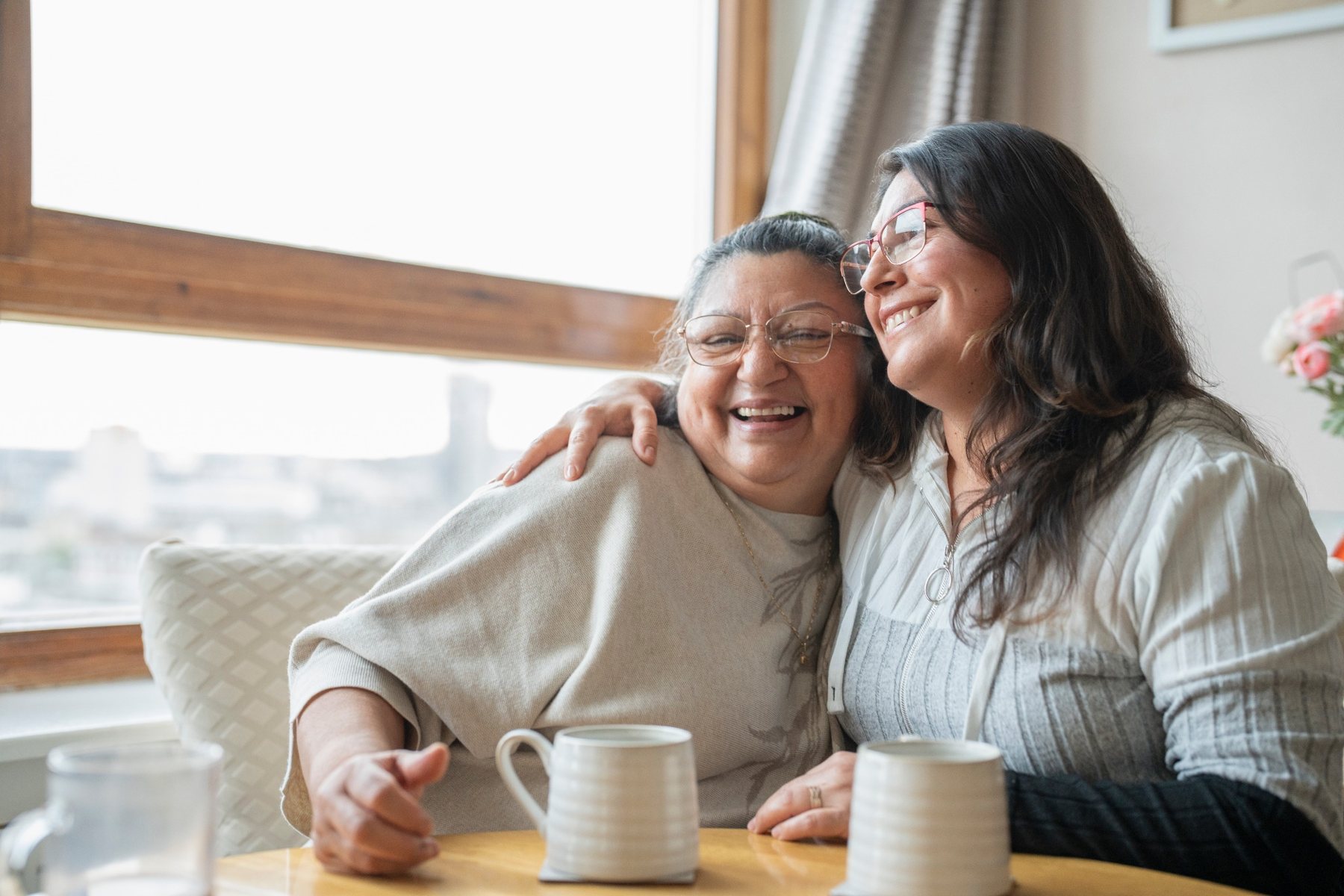 Two people smiling together indoors
